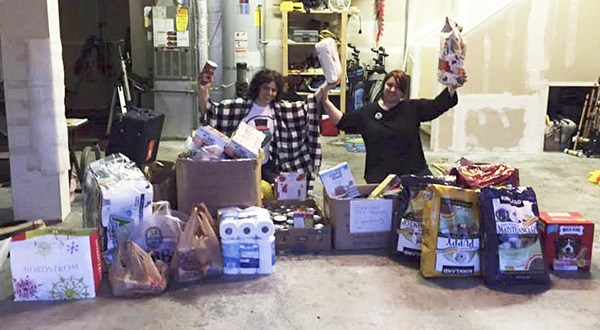 Sisters Megan Bishop (left) and Chanel Merritt with all the food and goods that were gathered from the Operation Wandering Waffle scavenger hunt in May.