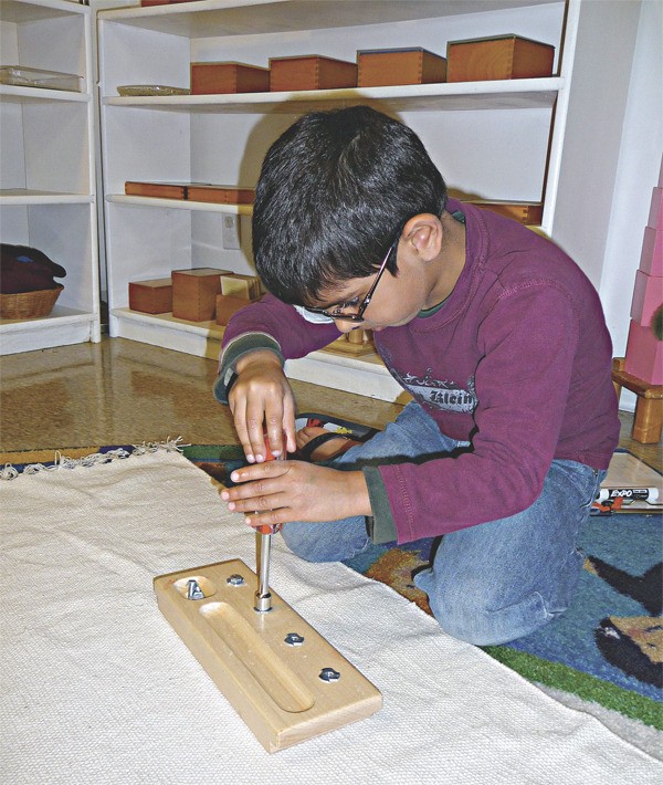 Vivek Prakriya concentrates on his task during a class at Reach Learning Community. Reach gives students the opportunity to pursue their passions while still learning the necessary skills to prepare them for school.