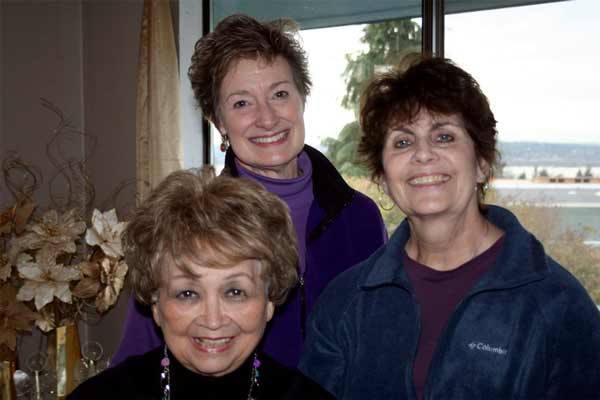 Lake Washington Singers member Diane Underwood of Redmond  (front) with president Karen Anderson (center) and Sandra Saenz at Anderson’s Kirkland home.