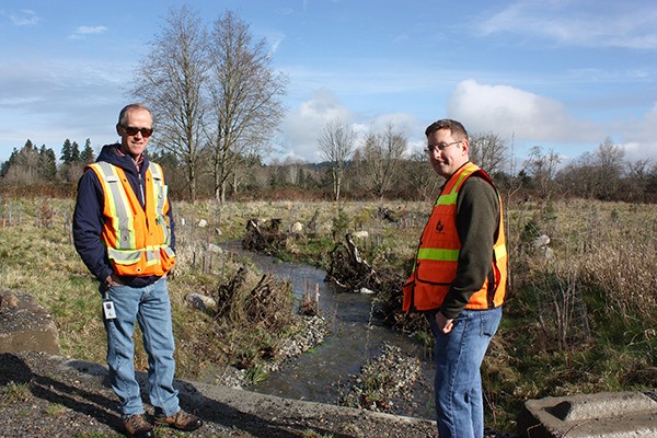 Roger Dane (left) and Steve Hitch from the the City of Redmond at Tosh Creek. The creek is the first of six on the city's Watershed Management Plan to be restored.