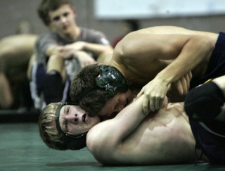 Andrew Colleran wrestles with teammate James Larson