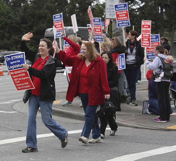 Redmond teachers participate in a Lake Washington Education Association walkout this morning at the corner of Avondale Road Northeast and Northeast 116th Street. Lake Washington School District teachers picketed around Redmond