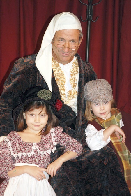 Sportscaster and motivational speaker Tony Ventrella (center) stars as Ebenezer Scrooge in Evergreen Family Theatre's production of 'A Christmas Carol.' With him are his granddaughters Edie (left) and Preston (right) Ventrella.
