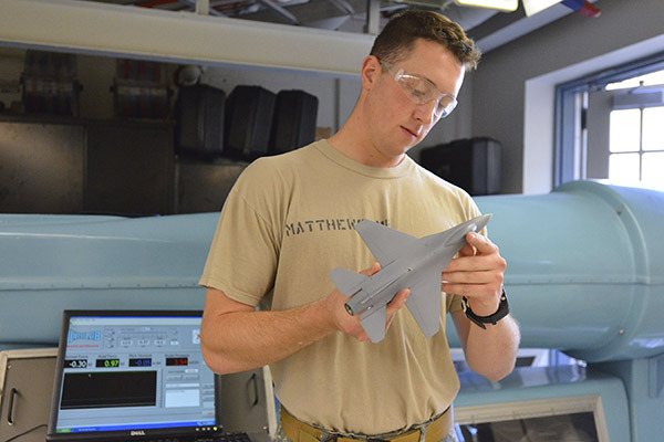 Redmond native Mike Matthews with a 1/48th-scale model of an F-16