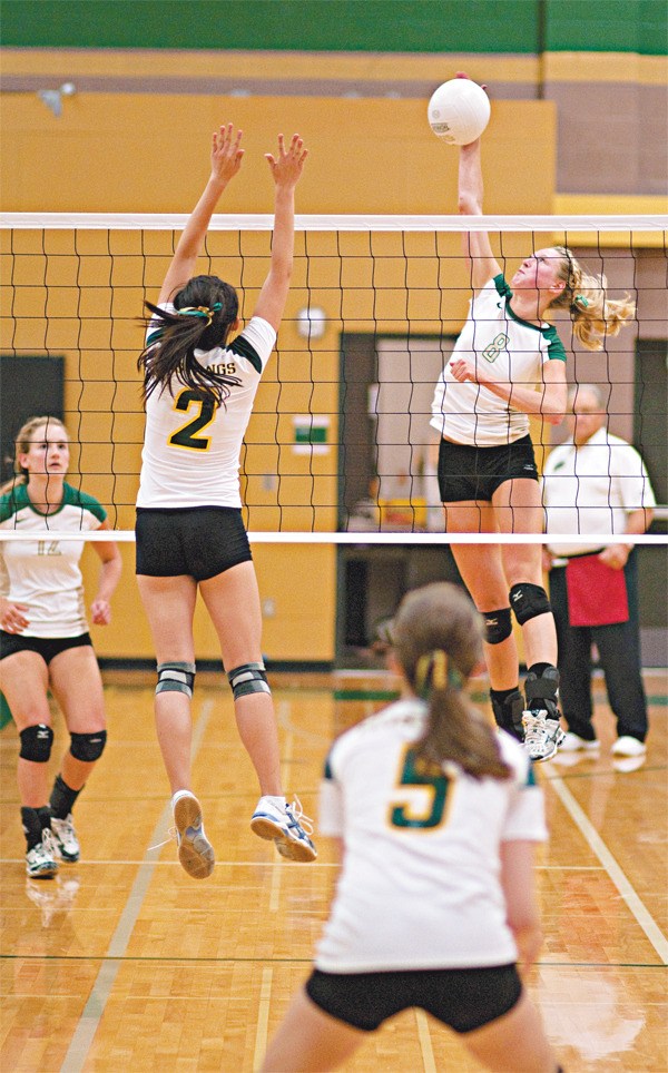 Bear Creek hitter Makena Schoene goes up for a kill while Redmond's Joy Zhang (No. 2) tries to block during the Grizzlies' 3-0 sweep at Redmond High School Tuesday night. Schoene and senior Nikki Peterson led the team with 10 kills each.