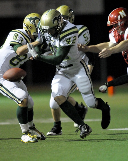Redmond High running back Clement Signoretty fumbles against Newport during the first tiebreaker game on Tuesday. Redmond had two lost fumbles in a 6-0 loss to Newport in the mini-playoff game.
