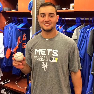 Michael Conforto displays the ball used for his first professional hit on Saturday.