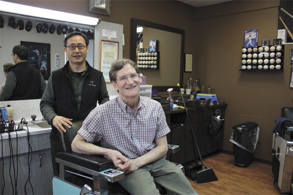 Young Choi (left) will be the new owner of Hill's Barbershop in downtown Redmond. Current owner Mike Hill is retiring after 40-plus years in the business.