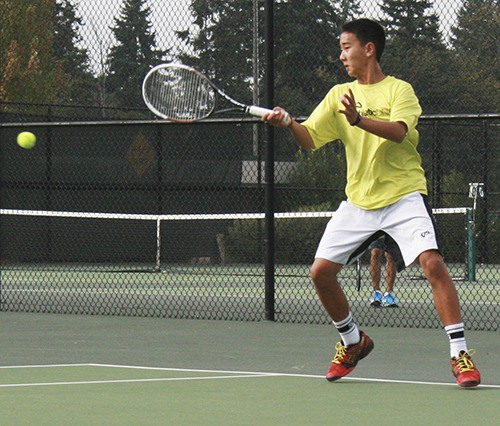Redmond's Adam Guo swings away while warming up for Tuesday's match against Mount Si.