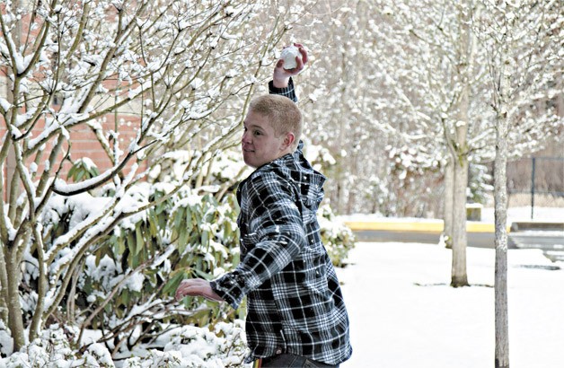 The Bear Creek School freshman Nick Wurden tosses a snow ball at some of his basketball teammates prior to an afternoon practice on Thursday. The Bear Creek School and Overlake School are currently on mid-winter break this week. Classes for both schools will resume Monday. Due to the snowy and icy weather
