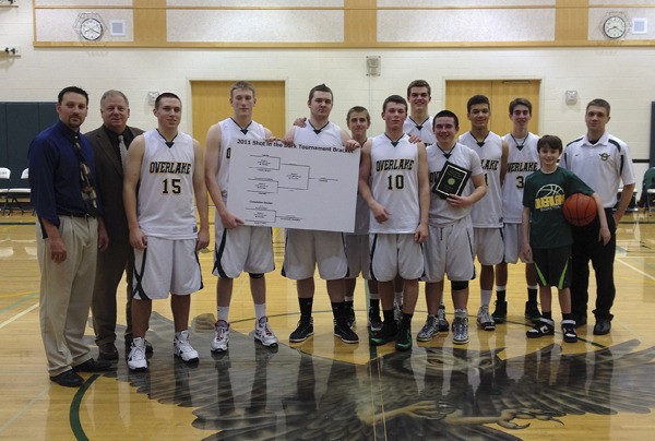 The Overlake School boys' basketball team poses with the winning bracket and championship plaque from the Shot in the Dark tournament held at the school. The Owls overcame a fourth-quarter deficit and defeated Charles Wright 54-44 in the finals.