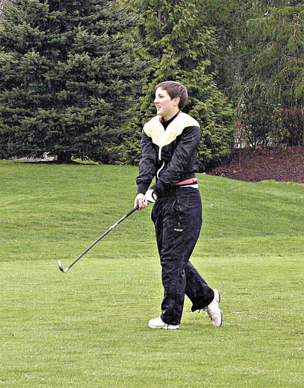Mustang junior Keira O'Hearn watches her tee shot on the first hole of Redmond's annual Par 3 Championship at Willows Run on a rainy Monday afternoon. O'Hearn is the highest returning state placer