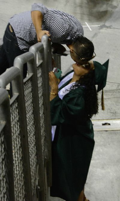 Redmond High School's Anahi Arjon receives a kiss from her boyfriend Joseph Grant before Friday's commencement ceremony at KeyArena. More photos to come.