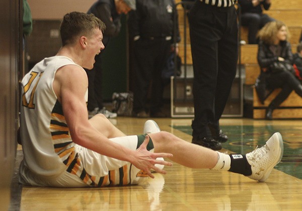 Redmond High senior forward Mitch Potter is ecstatic after driving the lane and converting a layin while getting knocked to the floor at the end of the first half against Skyline High on Tuesday night. Redmond won