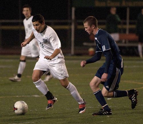 Bear Creek junior Nima Abtahi dribbles around a Providence defender during the Grizzlies' 2B state quarterfinals matchup against the Highlanders at Sammamish High on Saturday. The No. 1-ranked Grizzlies fell to Providence