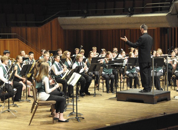 Evergreen Middle School band director Eric Peterson conducts band students during a concert.
