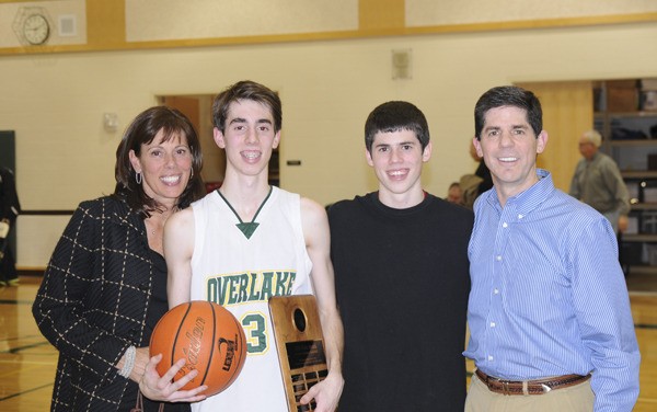 Overlake senior guard Dean Poplawski poses with his family after scoring his 1