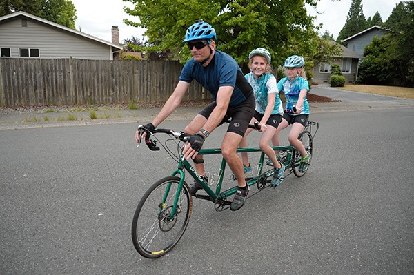 Stuart Hargreaves and his daughters Lili and Amelia on their triple tandem bike