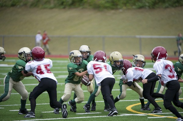 A group of Mustang Junior Football players scrimmage against Eastlake's team last fall at Redmond High School. The Redmond High football program will be holding its inaugural youth camp this summer in an effort to increase depth and turnout for future years.