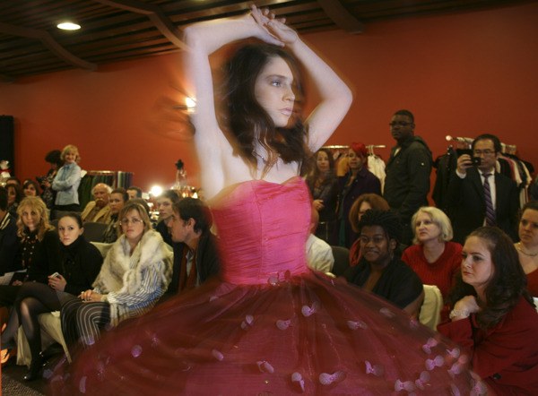 Tara Walrath models a dress by Laksmi McKenna at the Northwest Networking Umbrella. The event