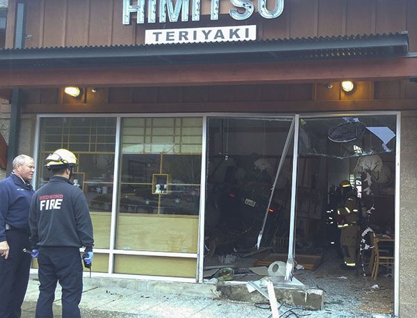 Redmond firefighters survey the scene during Thursday's accident at Himitsu Teriyaki.