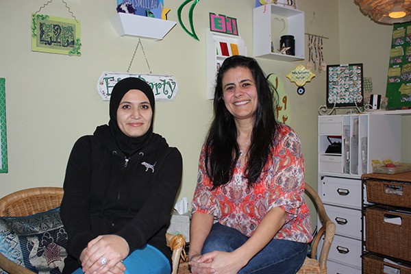 Kifah Hamdan (left) and Koloud Tarapolsi sit in an art studio in which she uses crafts to teach kids about Islam.