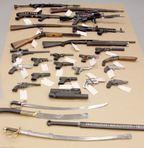 A collection of guns and swords found at a Kirkland house that was raided by Redmond and Kirkland police Oct. 4. Although the owner has been charged with buying and selling meth and heroin