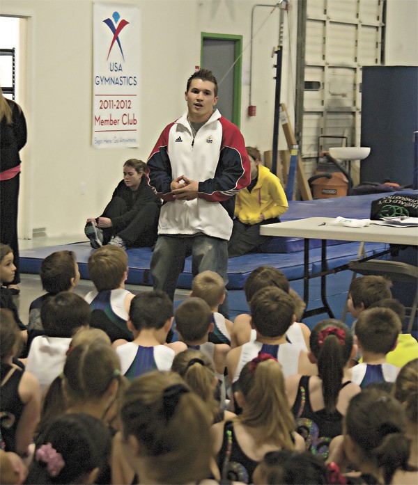 Olympic gymnast Jonathan Horton addresses a large group of youngsters at Redmond's Emerald City Gymnastics on Wednesday. Horton