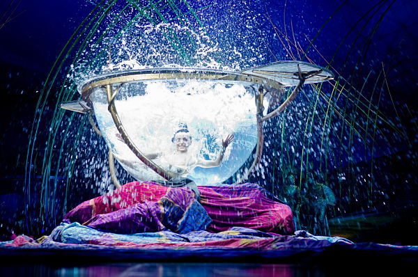 A Cirque du Soleil member performs in the water bowl