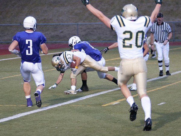 Redmond High receiver Cody Klepinger tumbles into the end zone after a 27-yard reception from quarterback Michael Conforto in the second quarter of the Mustangs' 28-7 victory over Lake Washington. Receiver Nikolaj La Cour (No. 20