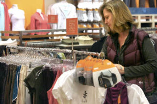 Donna Martinez looks through a rack of clothes while shopping at Lucy at Redmond Town Center. The store sells some clothing made of 100 percent organic cotton.