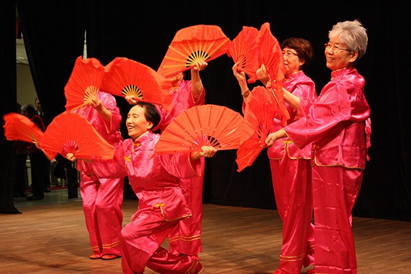 A group of fan dancers perform at the Redmond Senior Center during its Lunar New Year event.