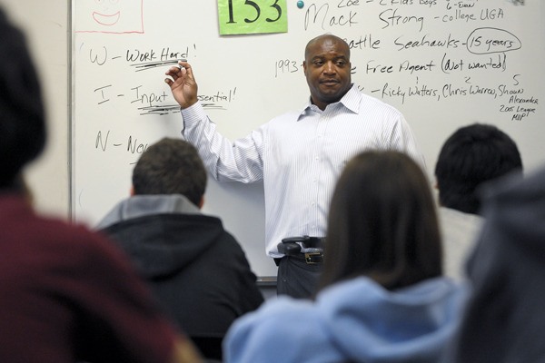 Former Seattle Seahawks fullback Mack Strong speaks to students during Tuesday's Career Day at Redmond Junior High. Strong used the letters of the word 'WIN' to impart this message to students: The 'W' stands for 'Work hard!' ... 'I' stands for 'Input is essential!' ... 'N' means 'Never give up!'