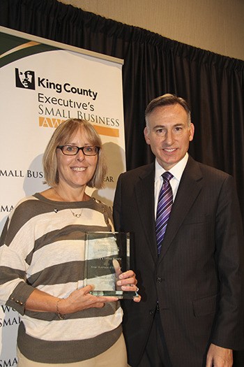 Keeney’s Office Supply owner Lisa Keeney McCarthy accepts the company’s Small Business of the Year award with King County Executive Dow Constantine on Sept. 25.