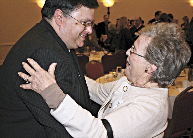 Redmond Mayor John Marchione gets a hug from Kathie Murray