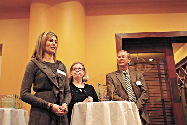 Marbella Day Spa and Boutique owner Debra Cobain (left) says a few words at the Greater Redmond Chamber of Commerce's annual awards luncheon after receiving the Champion of the Year award for 2010. Glugla has been part of the Chamber for about two and a half years.
