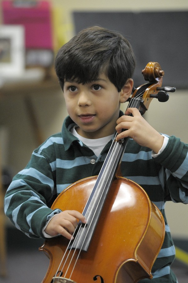 Six-year-old Diego Andaluz practices the cello at a recent music class with Suzuki Strings of Redmond.