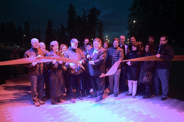 City of Redmond Mayor John Marchione cuts the ribbon for the opening of 'Signals