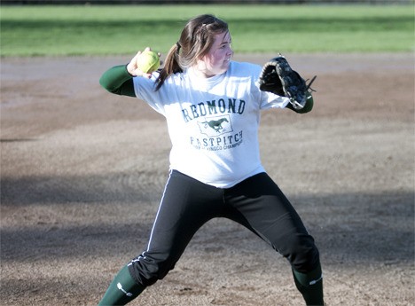 Senior third baseman Jenny Eisenmann throws across the diamond during a recent practice at Redmond High School. Eisenmann was on both of the Mustangs' state-bound teams in 2008 and 2009.
