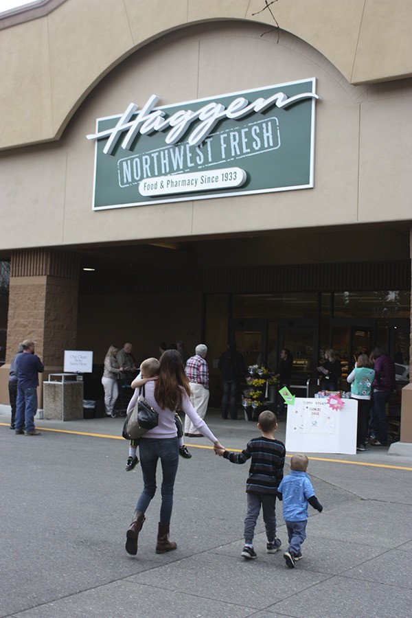 Shoppers make their way to the entrance of the new Haggen supermarket near Redmond on Tuesday. Manager Ben Floyd opened the doors a few minutes before the scheduled 4 p.m.  unveiling.
