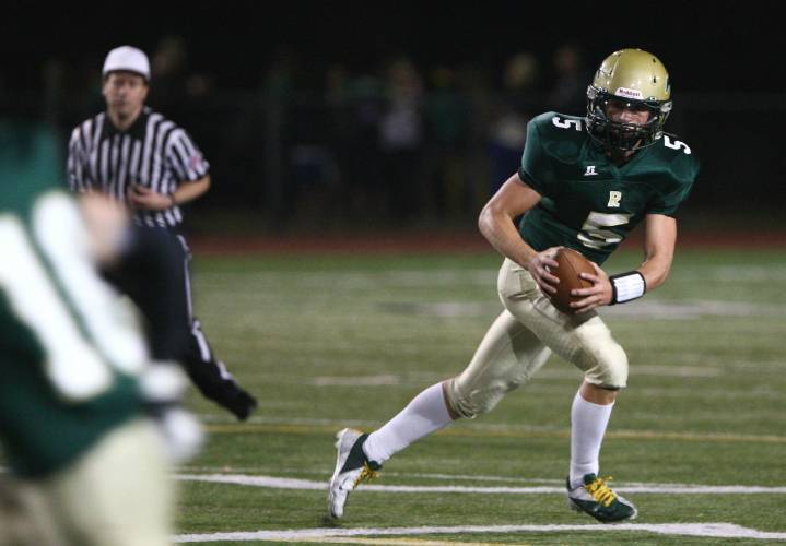 Redmond High quarterback Zach Wheat rolls out during Friday's game against Bothell High.