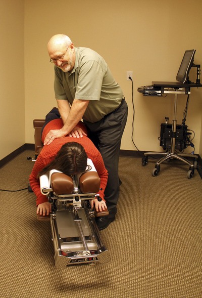 Dr. Jim Myers works on a patient at Myers Chiropractic Center in Redmond