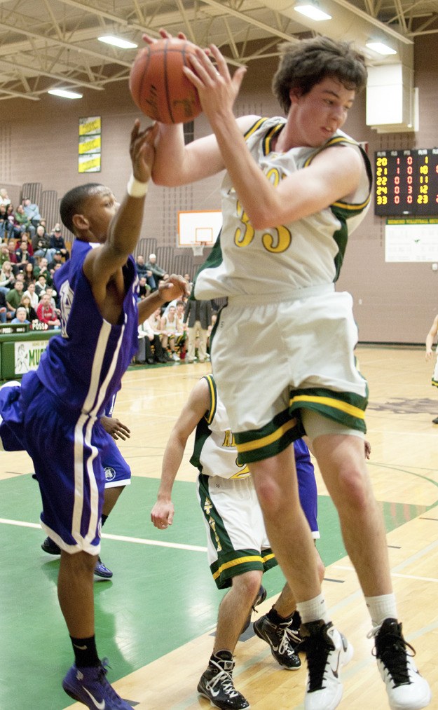 Redmond High junior Conner Floan tears down one of his nine rebounds in a Tuesday's 46-45 win against top-ranked Garfield. Floan scored the winning layup with 12.5 seconds left.