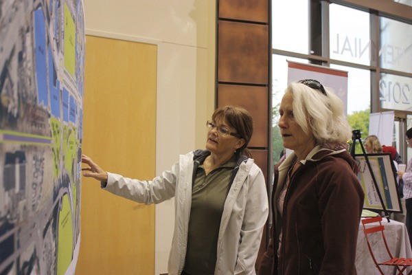 Melody Wilson (left) and Marilee Crivello look over projects for downtown Redmond.