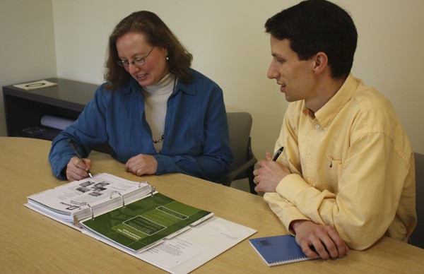 Kim Dietz (left) and Jeff Churchill review various aspects of housing within the City of Redmond that may be discussed during the six-week Citizen Academy