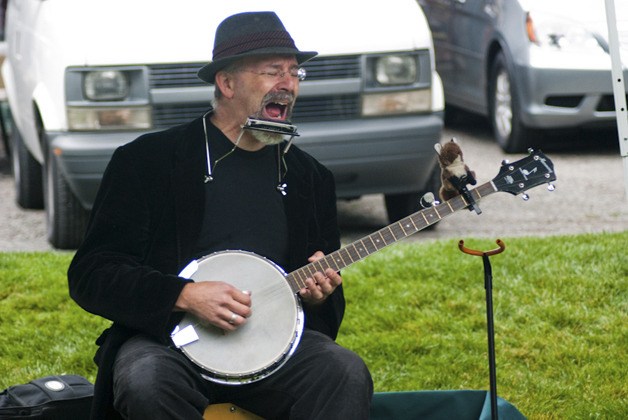 Darby Gerking delights local youths with songs and stories during Kids Day at the Redmond Saturday Market Sept. 4.