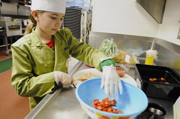 Nine-year-old Rachel Raines cuts tomatoes for her marinated tomato and pasta at the 4th Annual Sodexo Future Chefs: Healthy Snack Challenge. Rachel is a fourth-grader from Horace Mann Elementary School in Redmond and received the judges' choice award. Pasta is her specialty and said this particular dish is her favorite to prepare.
