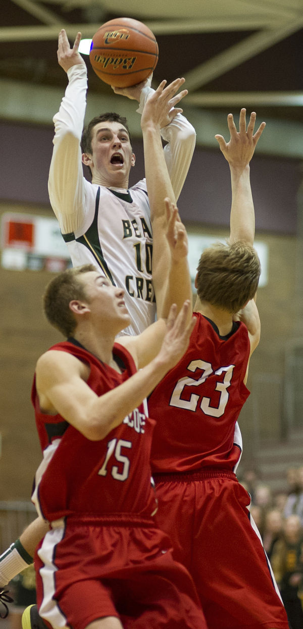 Bear Creek's Collin Feight shoots over a pair of Lind-Ritzville/Sprague players last Saturday.
