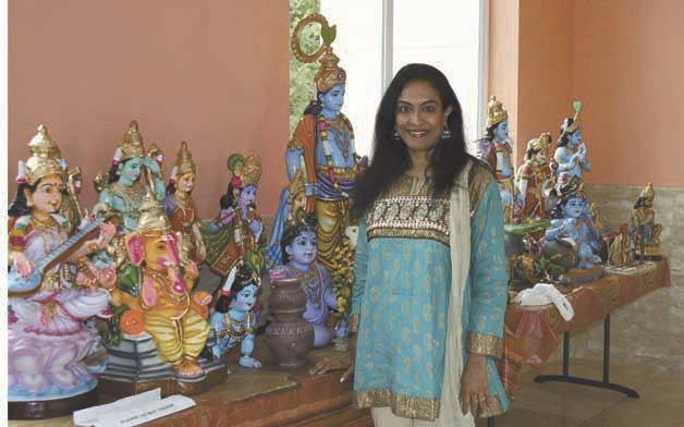 Wearing traditional Indian clothing and surrounded by colorful Indian dolls