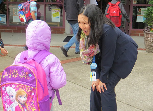 Albert Einstein Elementary School principal Robin Imai welcomes a student to school on their first day Tuesday morning.